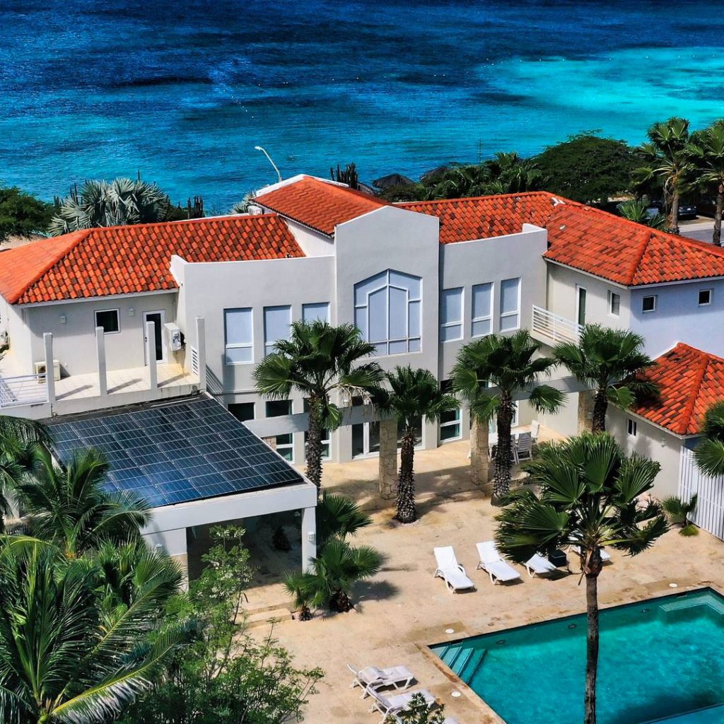 aerial view of a vacation home and beach