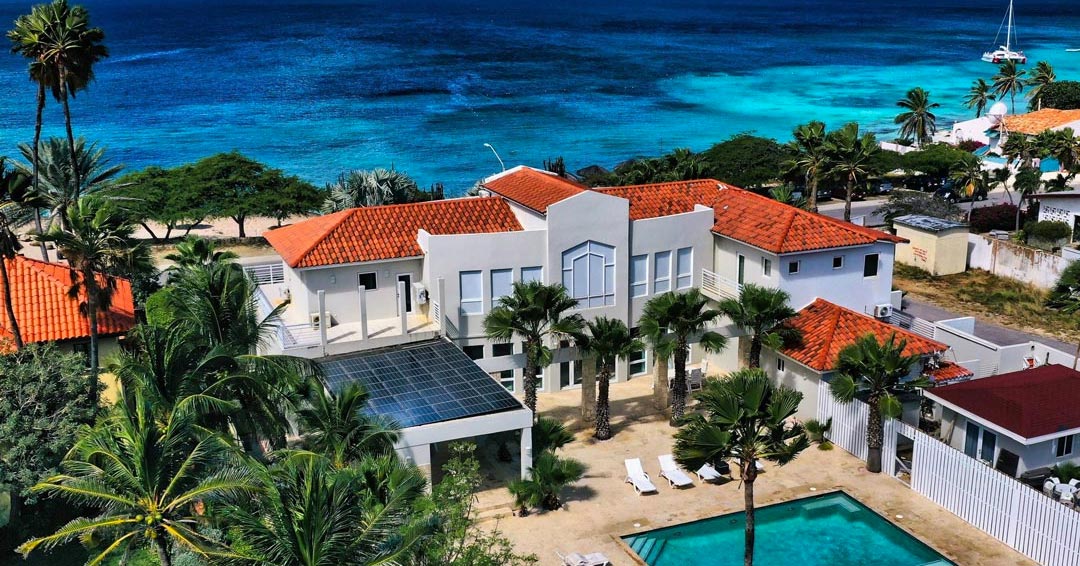 aerial view of a vacation home and beach