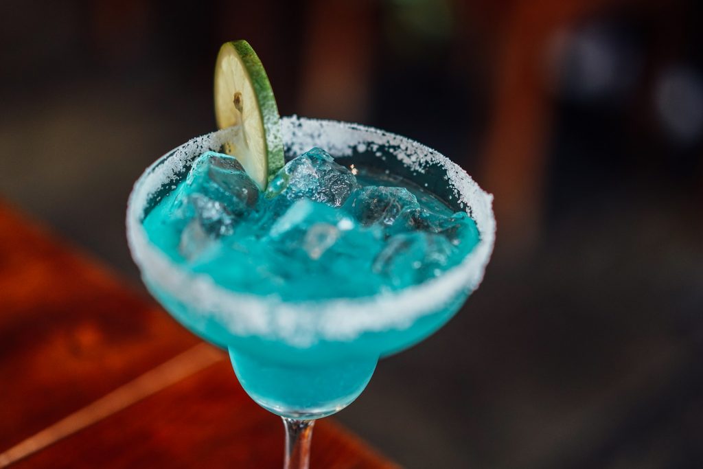 blue margarita with lime wedge