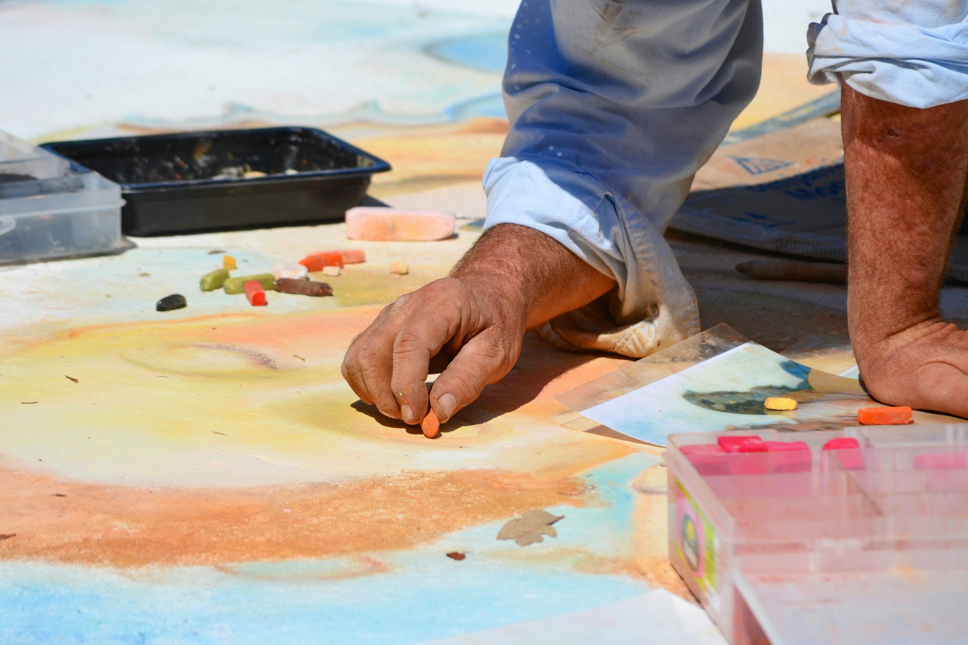 Person drawing on sidewalk with chalk